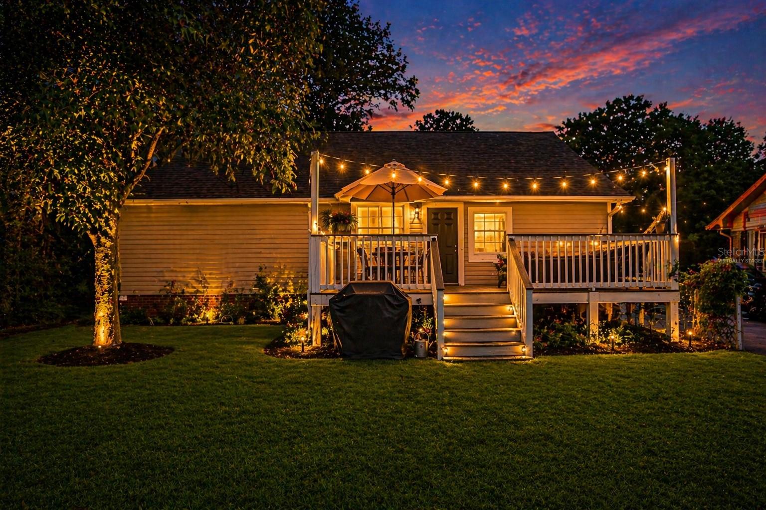 Virtually staged. Backyard at dusk highlighting the outdoor living space and entertaining potential.