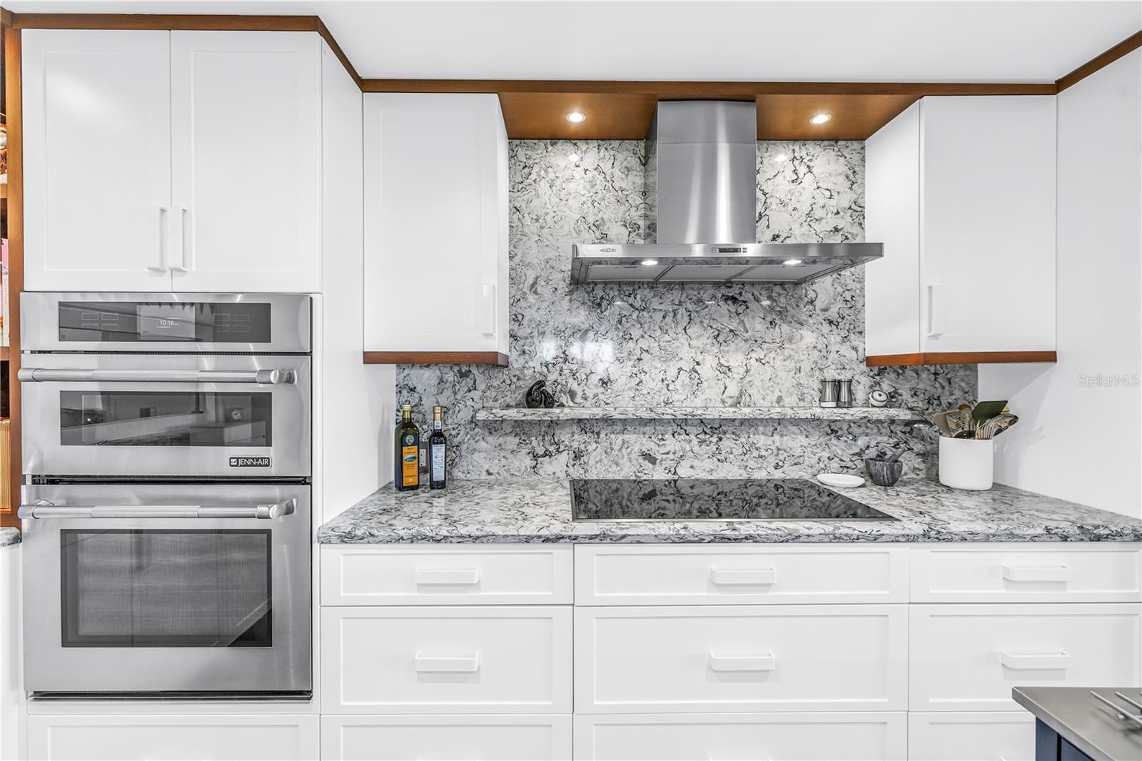 Microwave/wall oven combo with convection oven, 5 burner induction cooktop with touch control and stainless chimney wall hood... all Jenn Air appliances