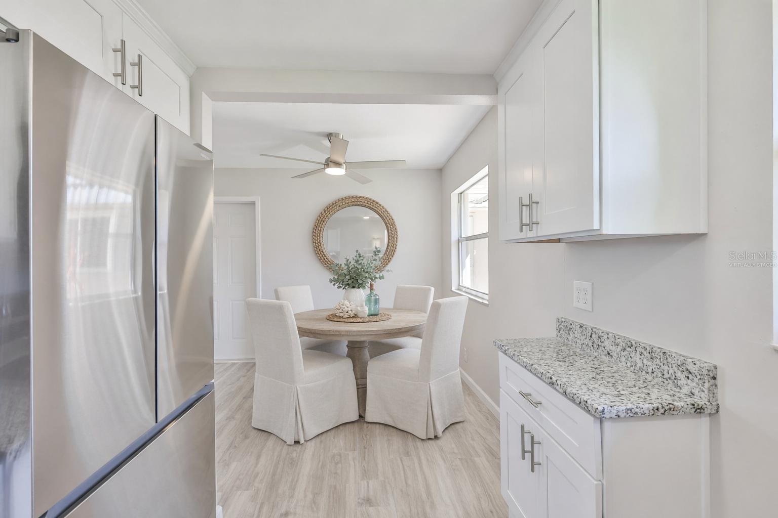 virtually staged dining area off of the kitchen