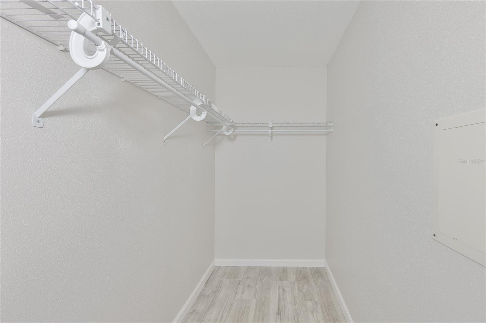 Primary bedroom walk in closet