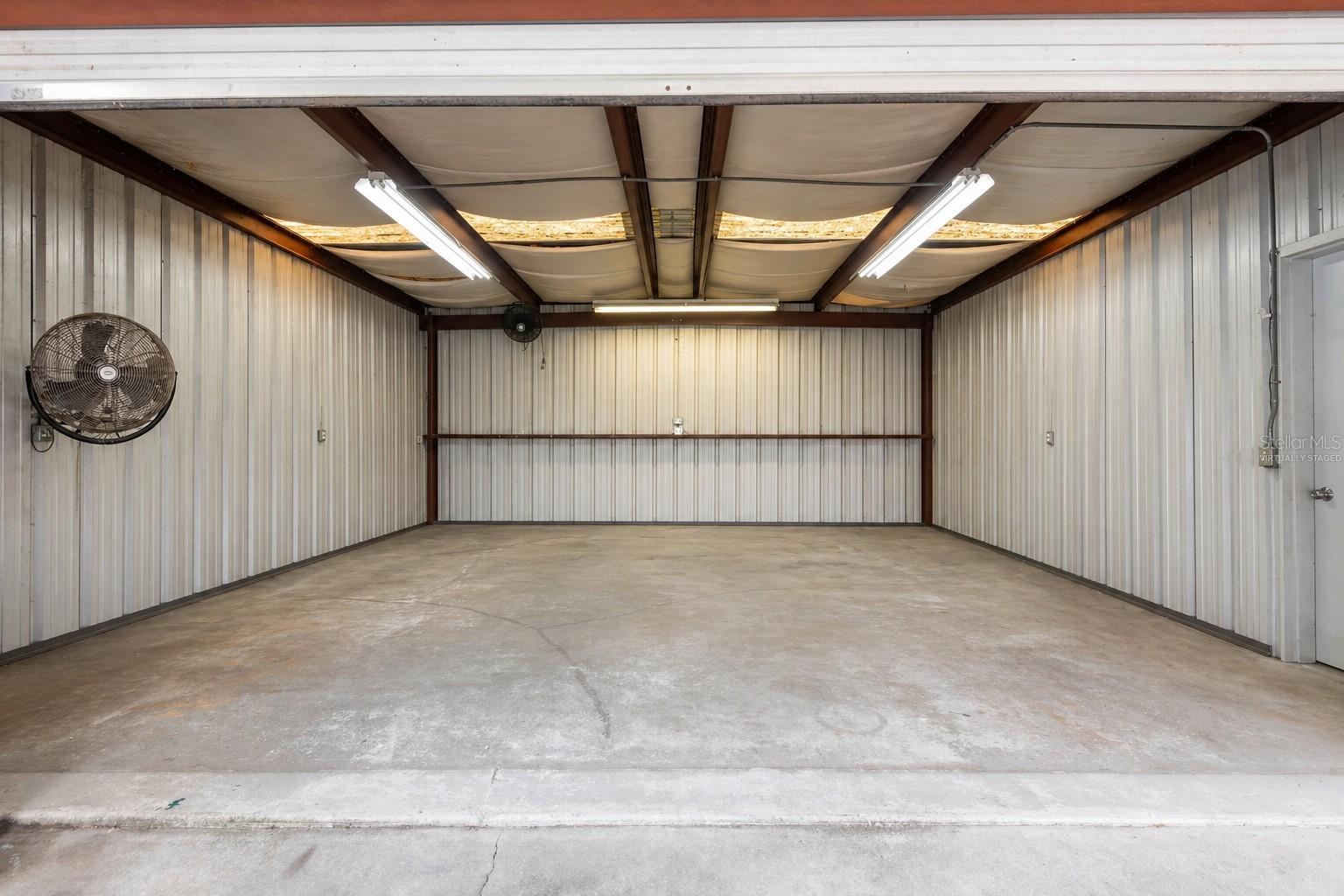 Virtually staged with items removed. Room to store a boat, trailer and supplies for business owners.
