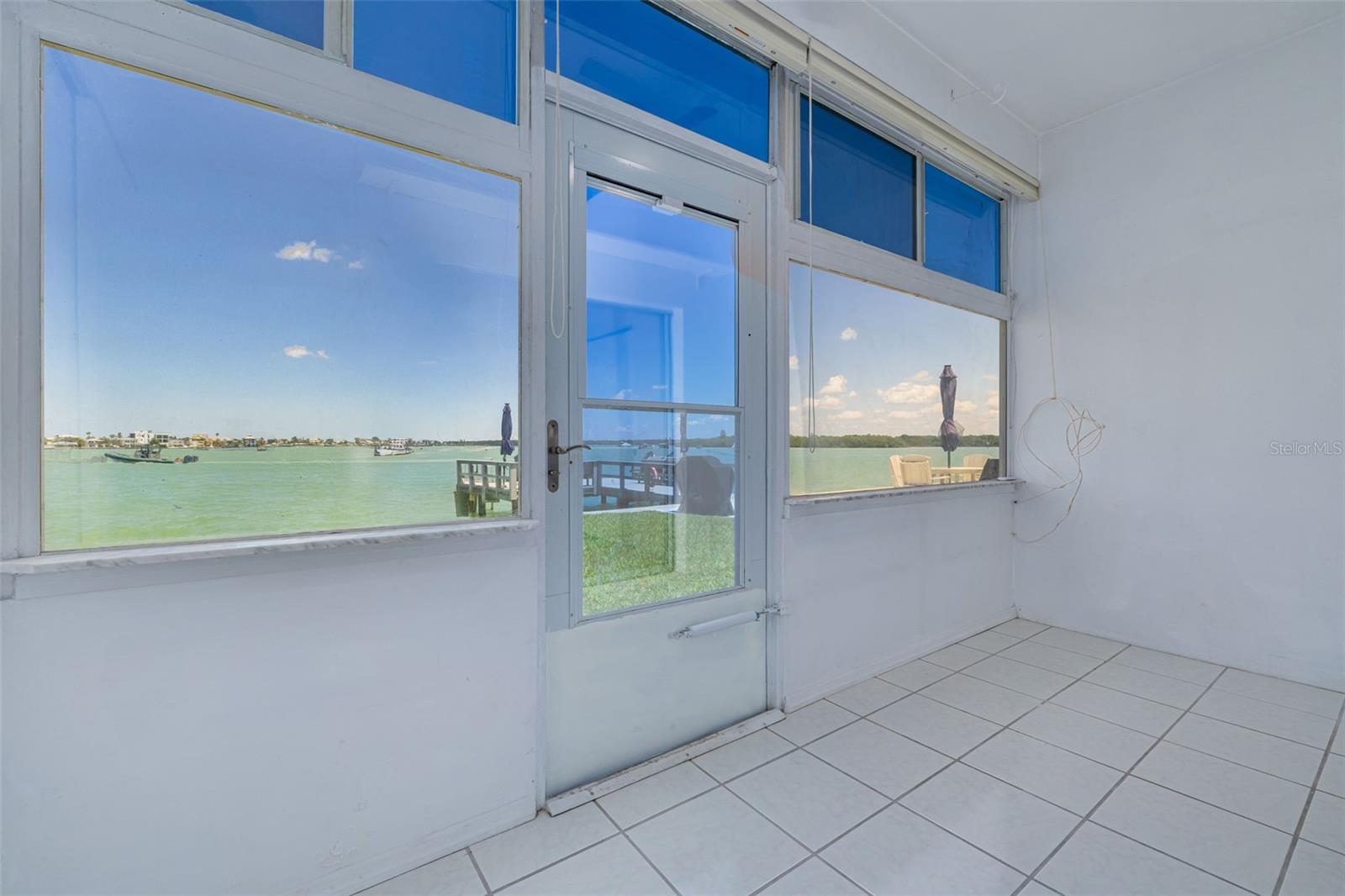 Florida room with door directly out to water