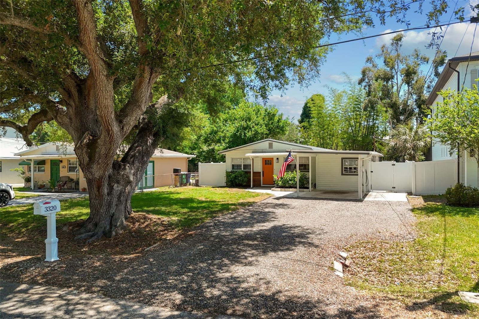 Front of Home w/Beautiful Oak & Gravel Driveway