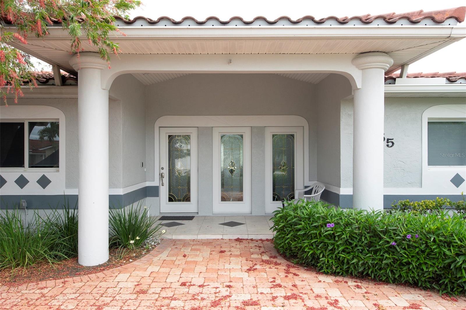 Entryway features stately white columns