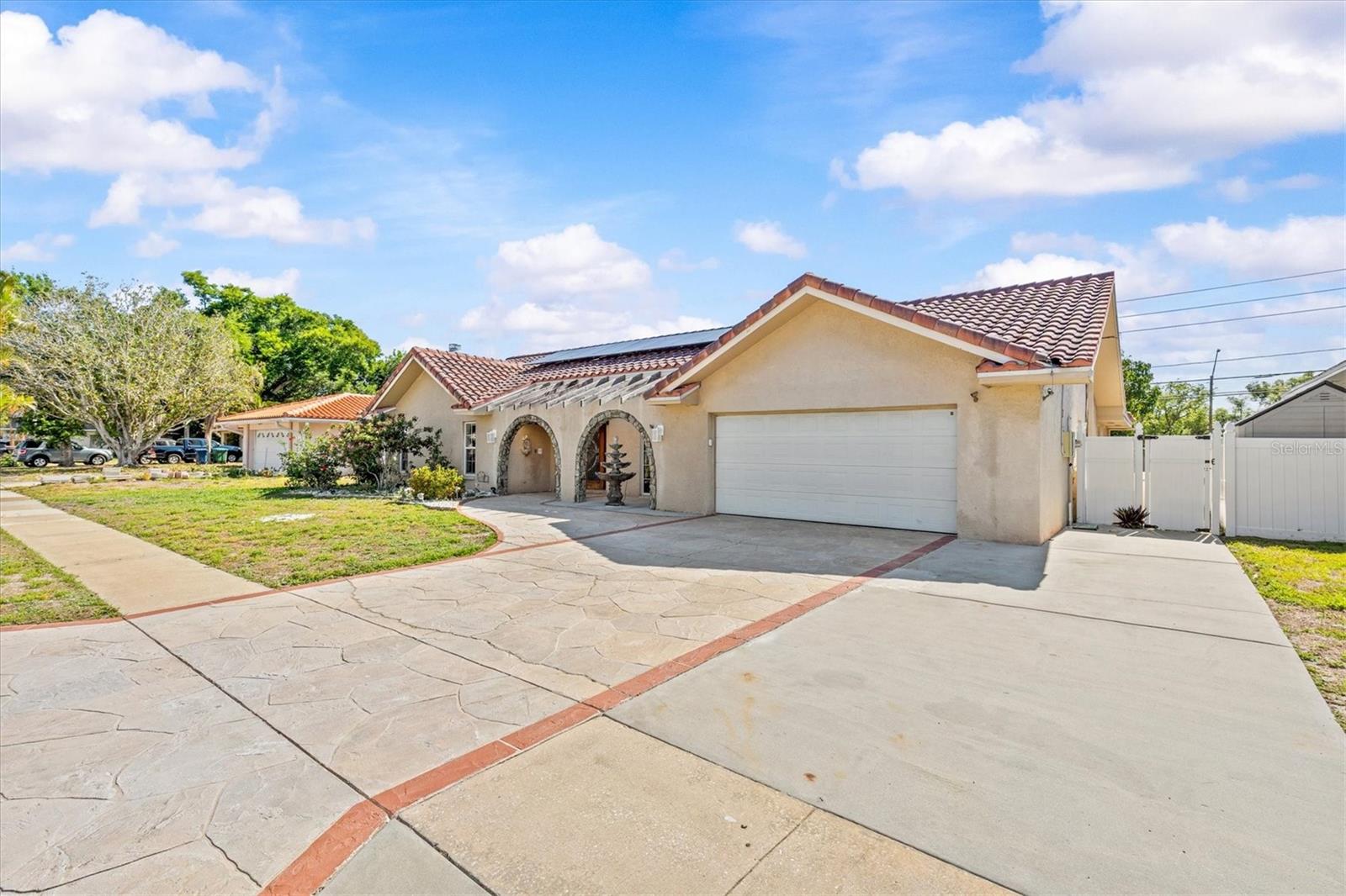 Bonus parking pad provides added convenience—perfect for guests, golf cart, or extra vehicle space.