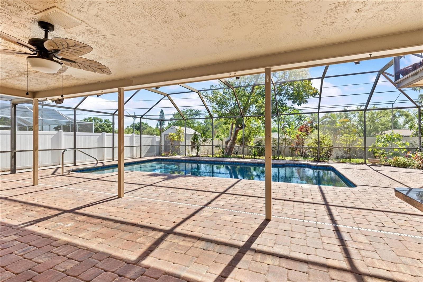 Newly resurfaced pool with pavered deck area, offering a refreshed and inviting outdoor living space.”