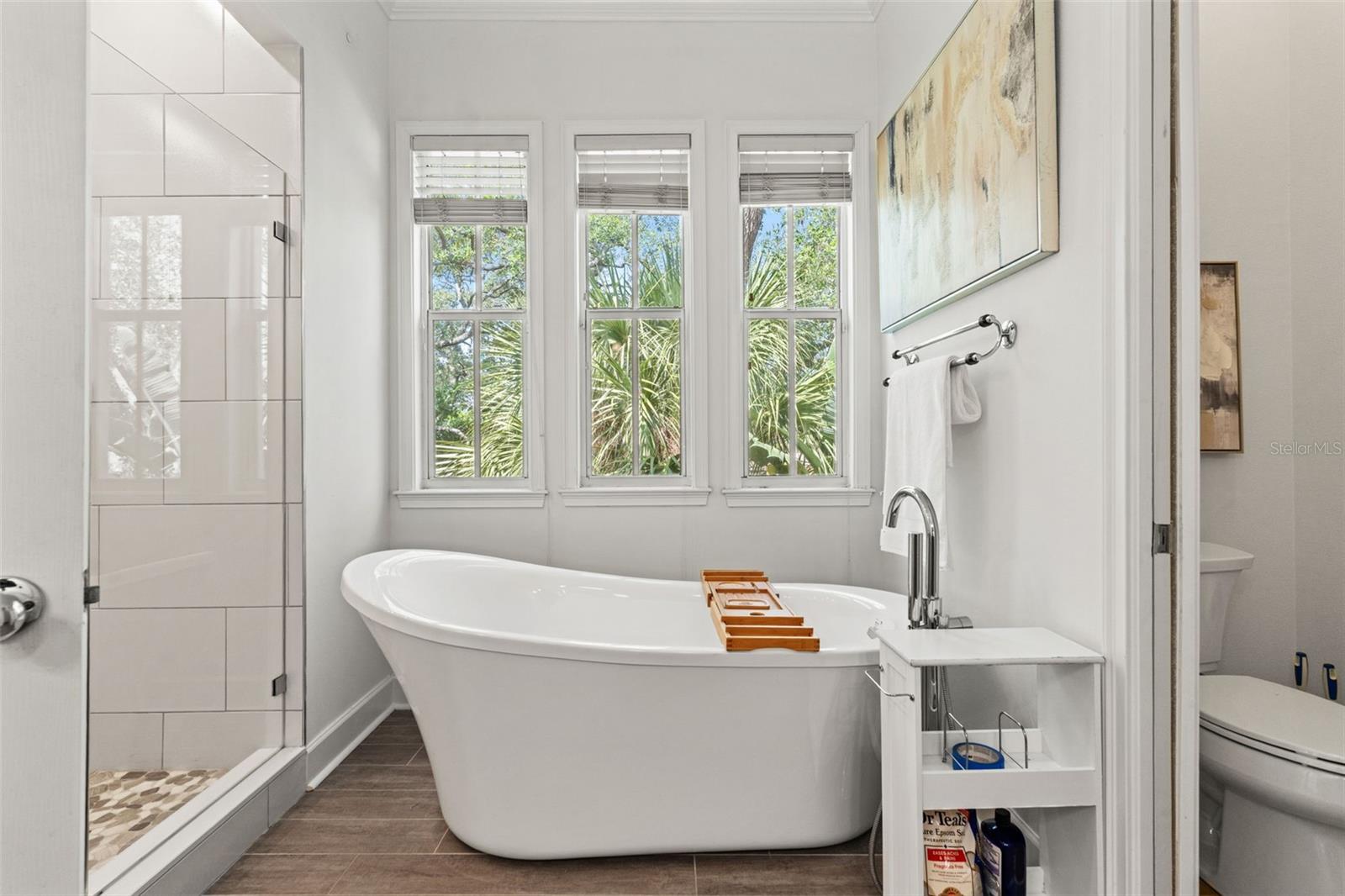 Primary bedroom ensuite with walk in shower and freestanding tub