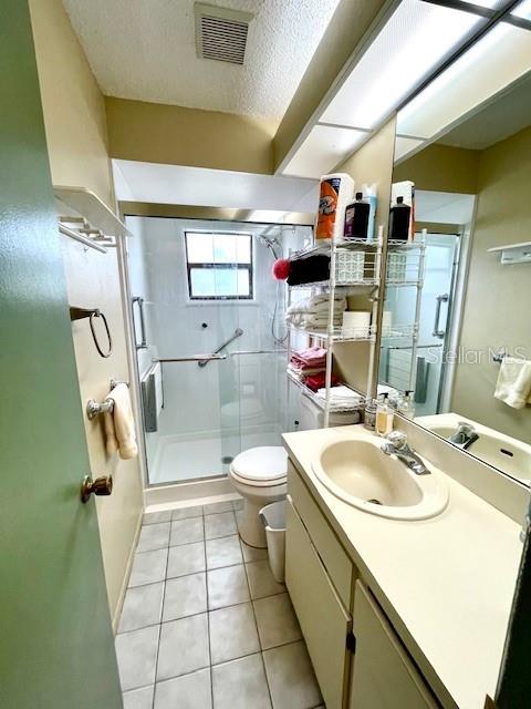 Guest full bathroom with walk-in glass enclosed shower.