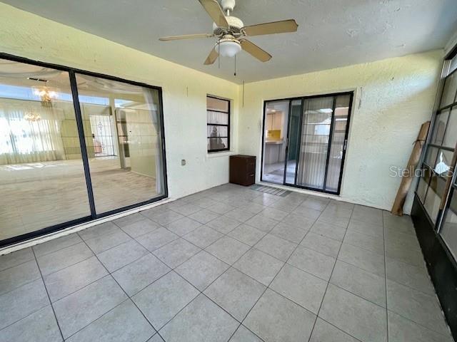 Vinyl/screen enclosed lanai with newer flat roof (2021).