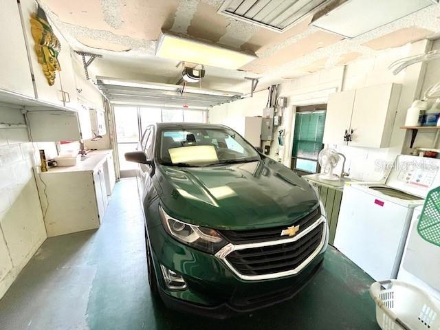 Single-car garage with built-in cabinets.