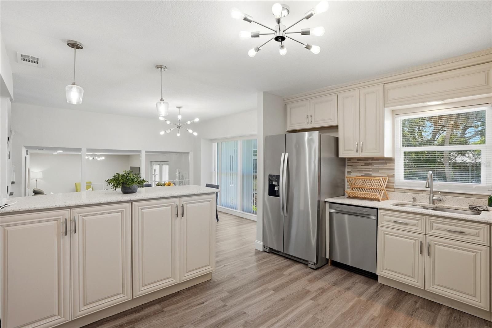 Kitchen w/ refrigerator, sink and high top bar