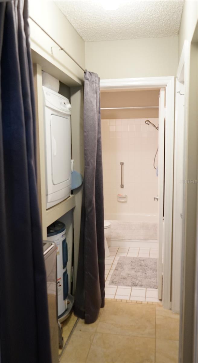 hallway at guest bedroom has laundry and storage space