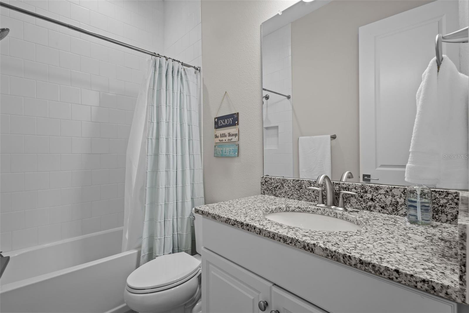 Private en-suite bathroom connected to the guest bedroom.