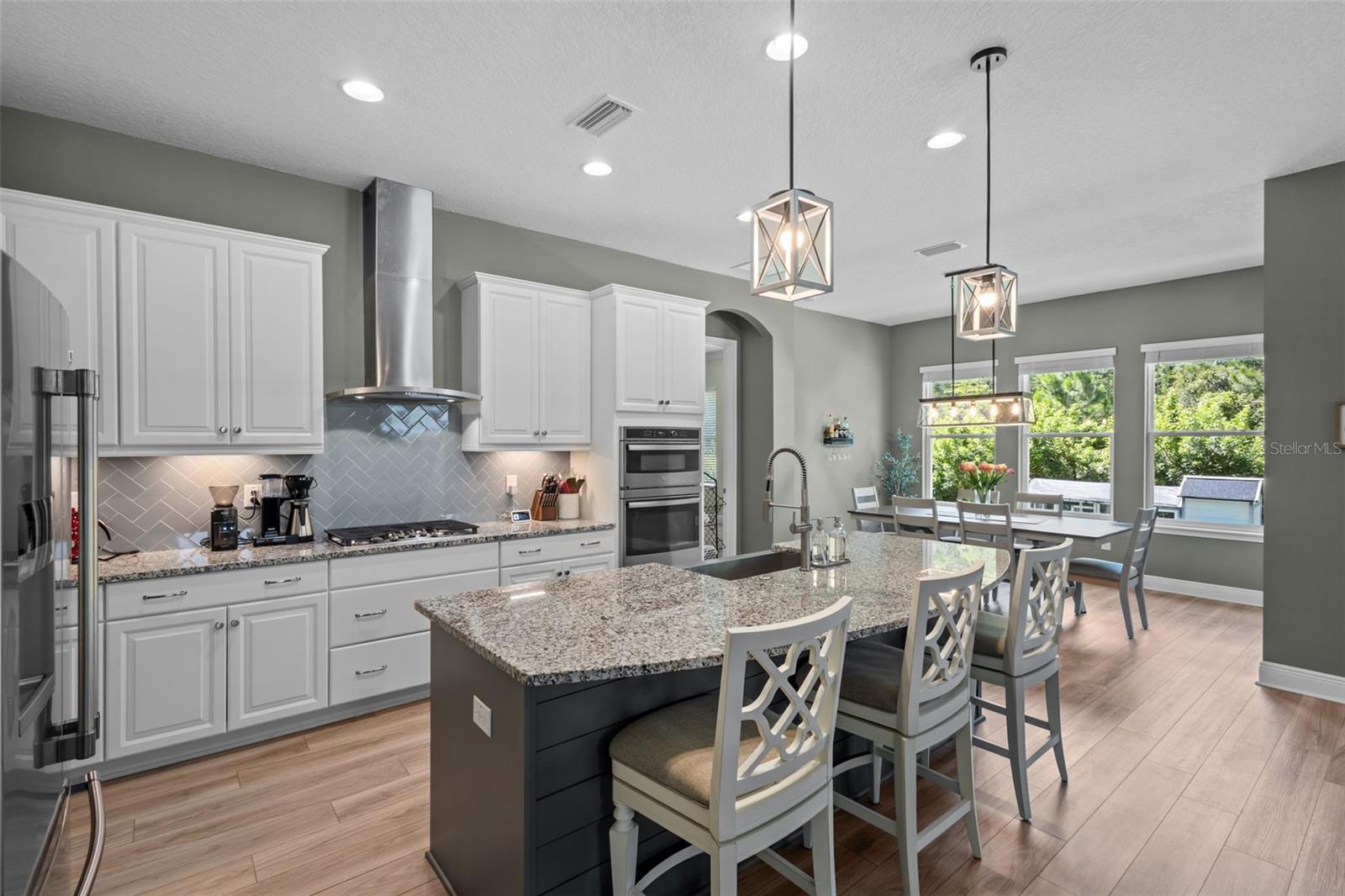 Spacious kitchen with tall cabinetry, stainless steel appliances, and generous storage.