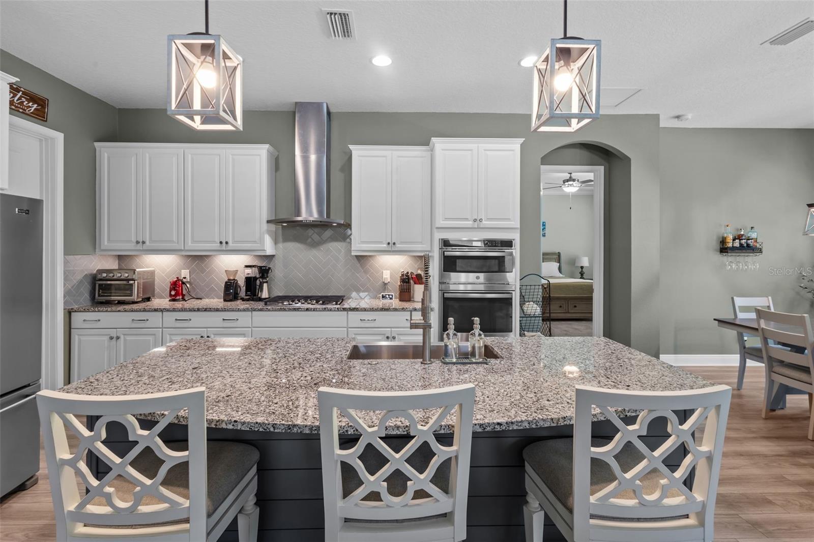 Spacious kitchen with tall cabinetry, stainless steel appliances, and generous storage.