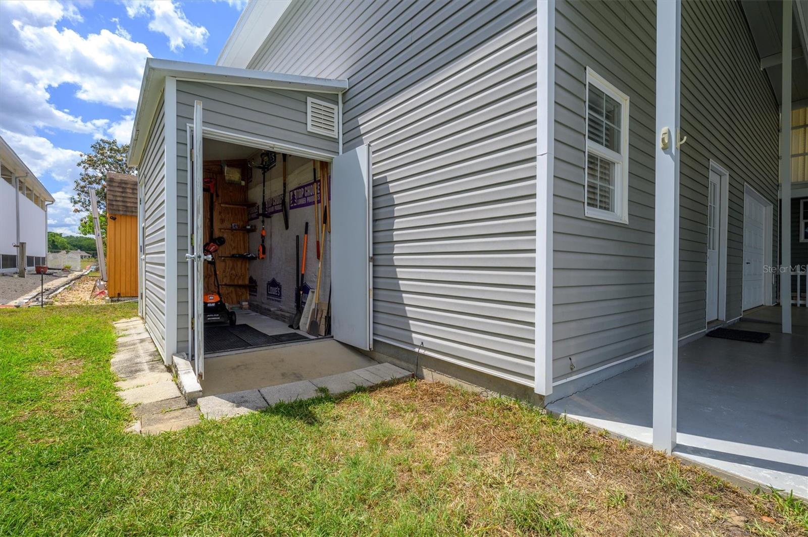 Golf cart and Tool shed.  Mower and tools can remain.