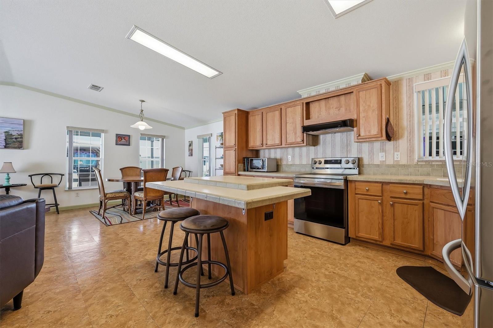 Open kitchen with a lot of cabinets. All appliances remain.