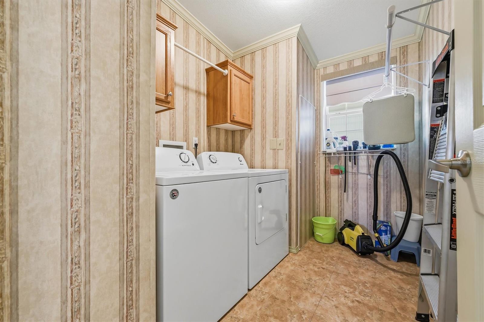 Laundry room in hallway.  Washer and dryer can remain.