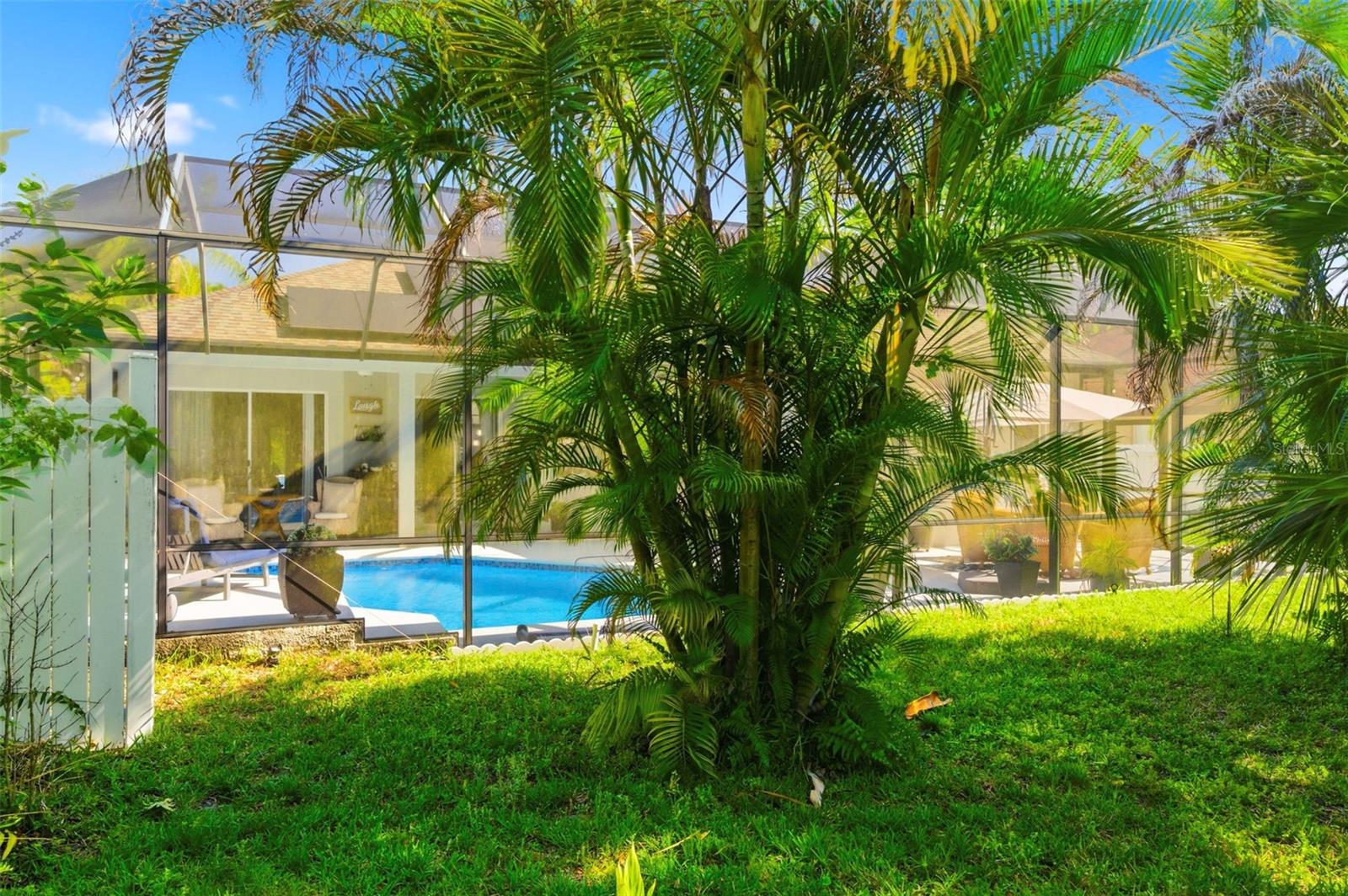 Expansive screened-in lanai offers an ideal outdoor living space with extended seating areas perfect for relaxing or entertaining. Enjoy the privacy and peaceful setting of a backyard that backs to a conservation area, providing serene views and no rear neighbors. This thoughtfully designed space allows you to fully embrace Florida living year-round.