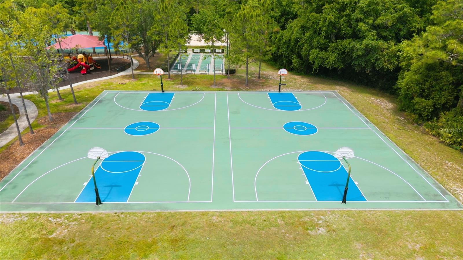 Basketball courts surrounded by lush vegetation