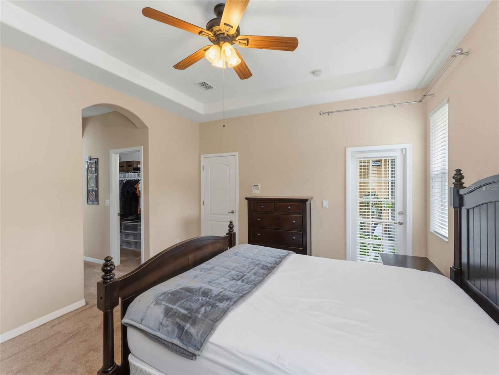 Primary bedroom with French door to screened porch; 2 walk-in closets and tray ceiling