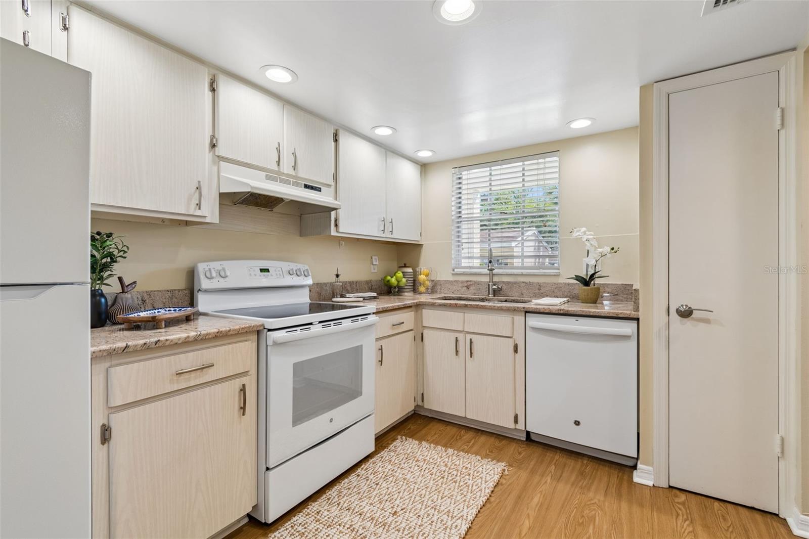 Kitchen with granite countertops, newer appliances, & pantry