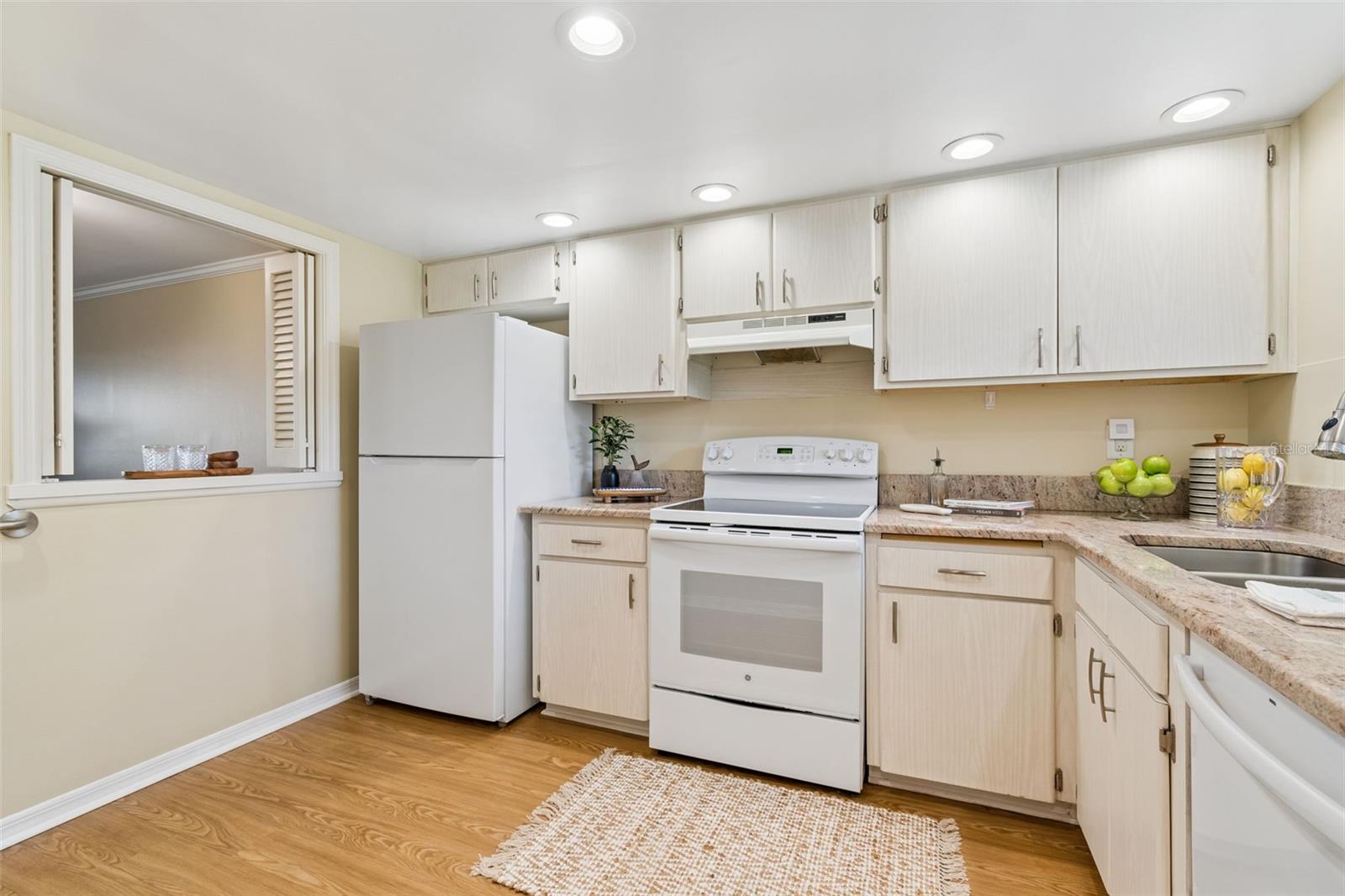 Kitchen with a window to the open dining and living room