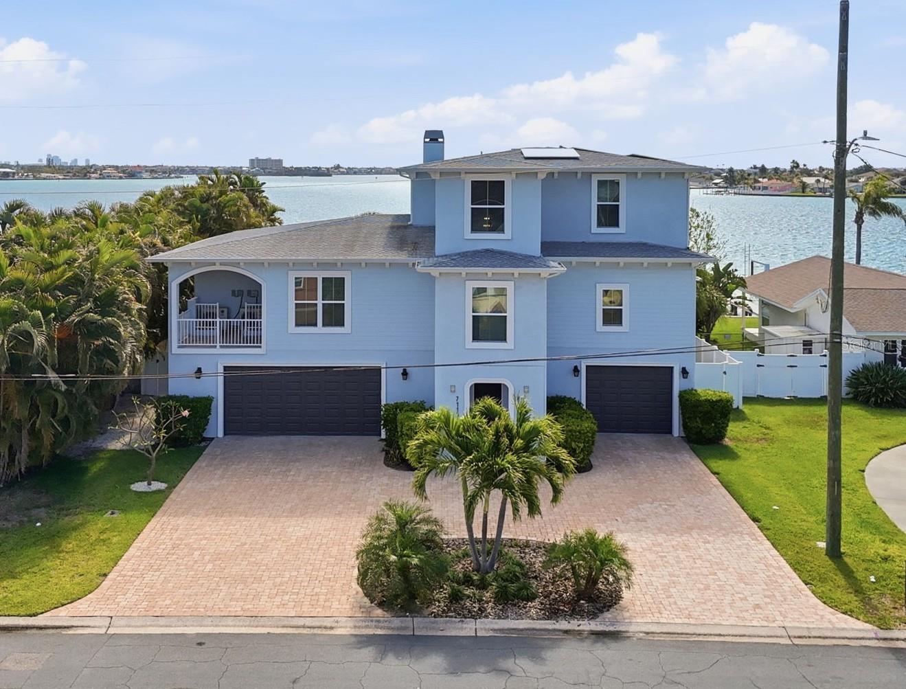 This 2018-built St Pete Beach waterfront estate has beautiful curb appeal in the front, and a dreamy wide open panoramic water view in the back. The lot is 10,502 square feet and includes 75' of waterfront.