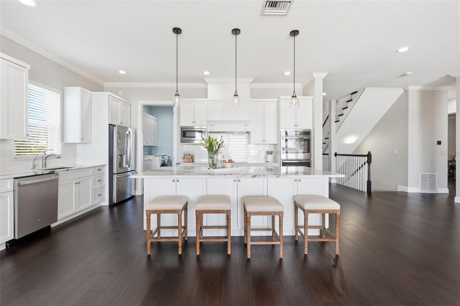 Whether it's pizza night or fancy fine dining with friends, this beautiful chef-inspired kitchen has you covered. The center island has stone counters and custom cabinetry to spare.