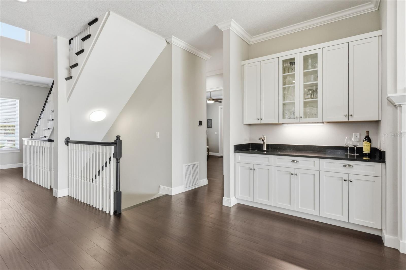 The wet bar with sparkling black galaxy granite is pretty and functional, making it pretty functional.