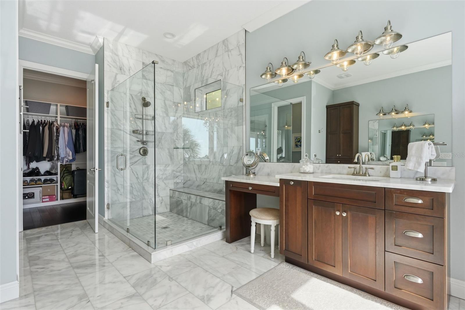Master bedroom suite bathroom with oversized shower, two separate vanities + makeup vanity. The walk-in closet in the background is also spacious and phenomenal.