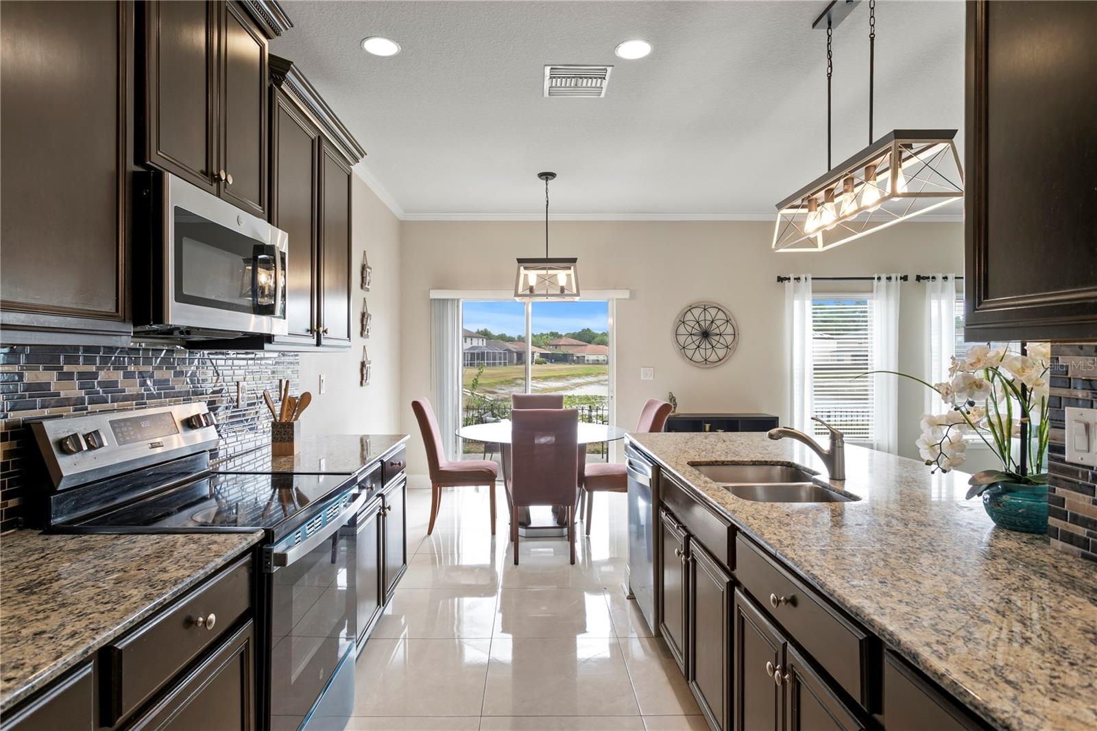 Kitchen features recessed lighting and pendant lighting