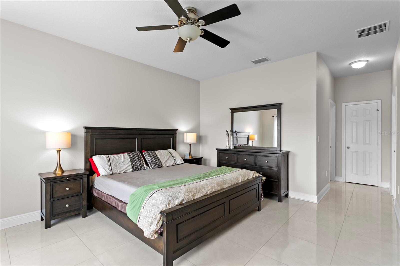 Large primary suite with ceiling fan