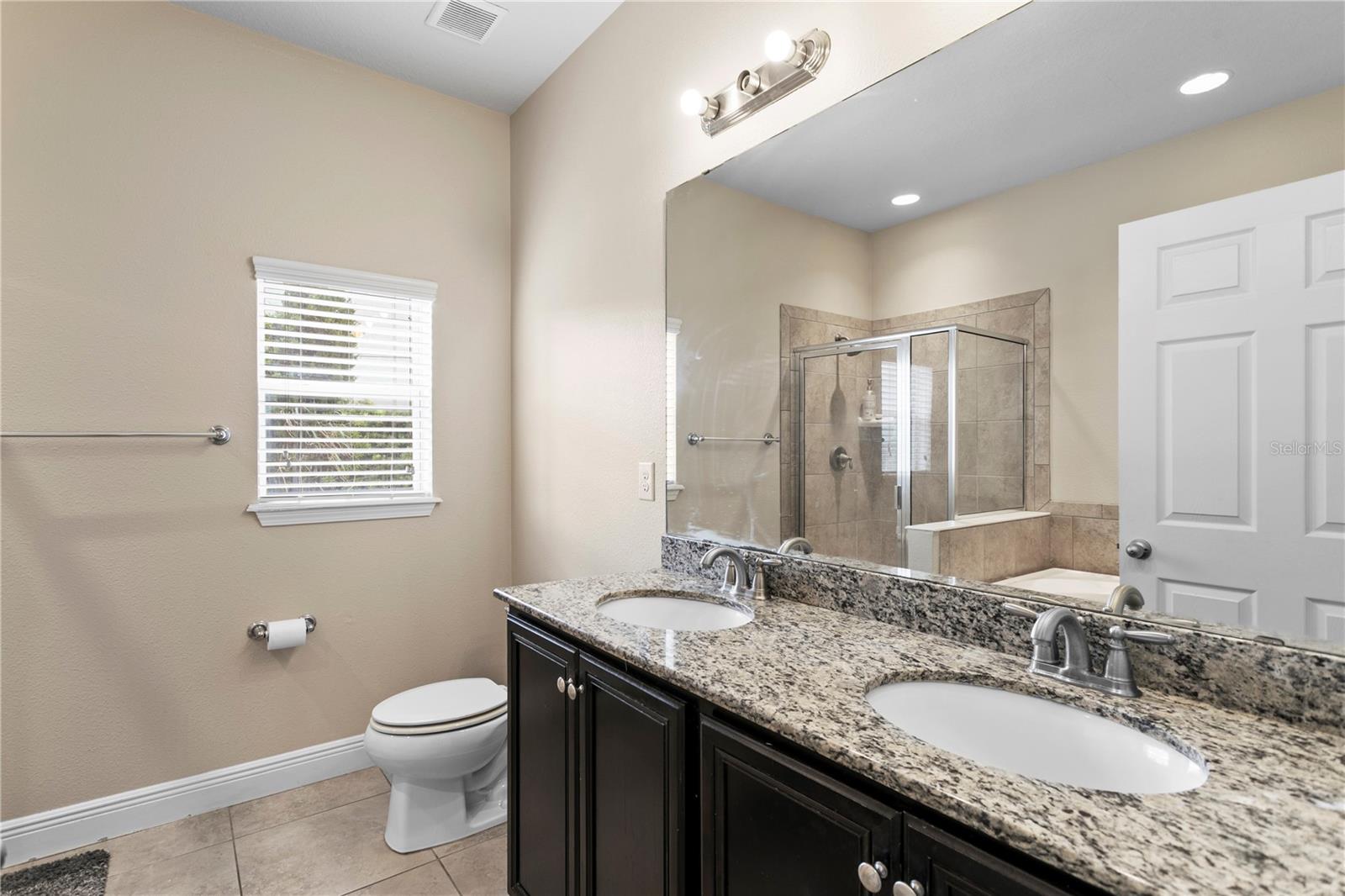 Large primary suite with dual sinks and granite counters