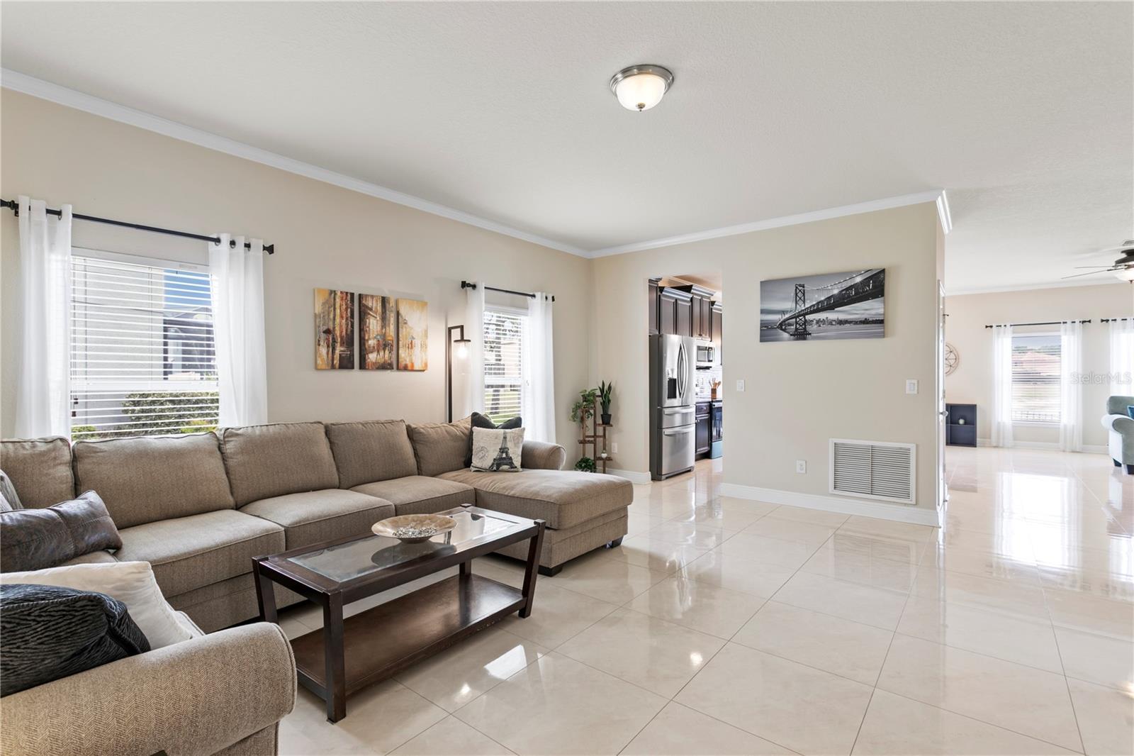 Formal living room off foyer with 24" porcelain tile and crown molding