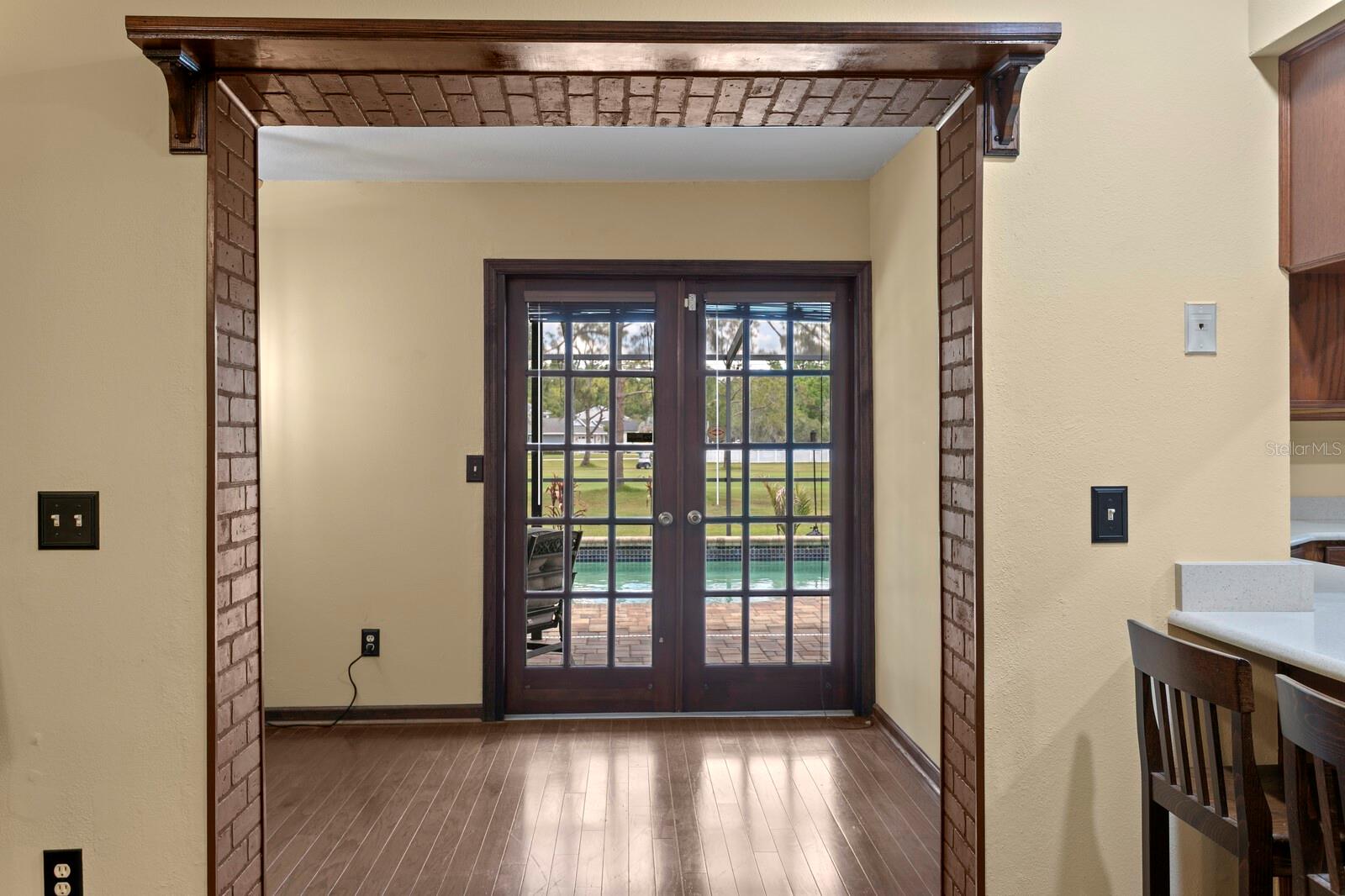 French doors from lanai into office/library space