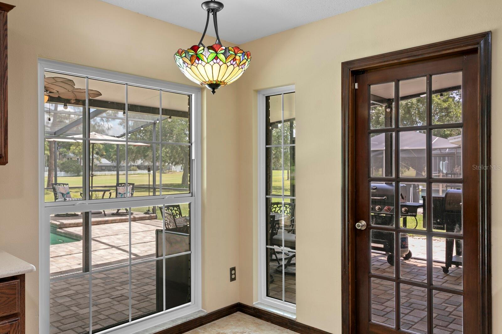 Casual dining area in kitchen with pool views