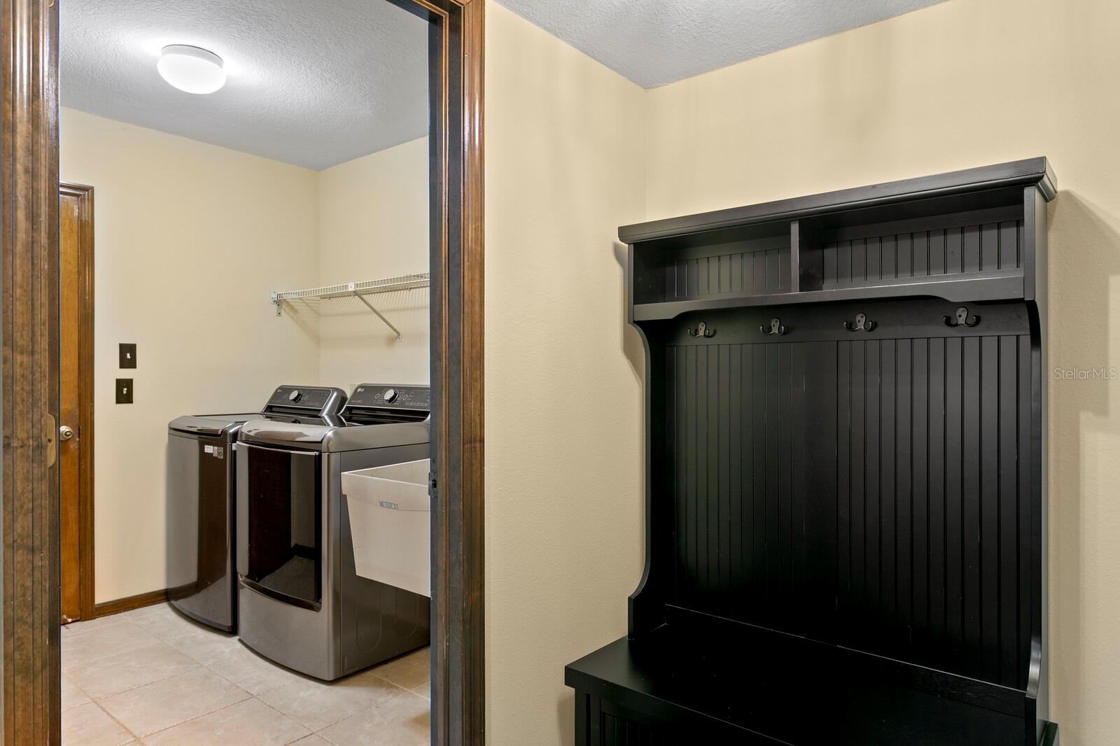 Storage area off foyer and utility room