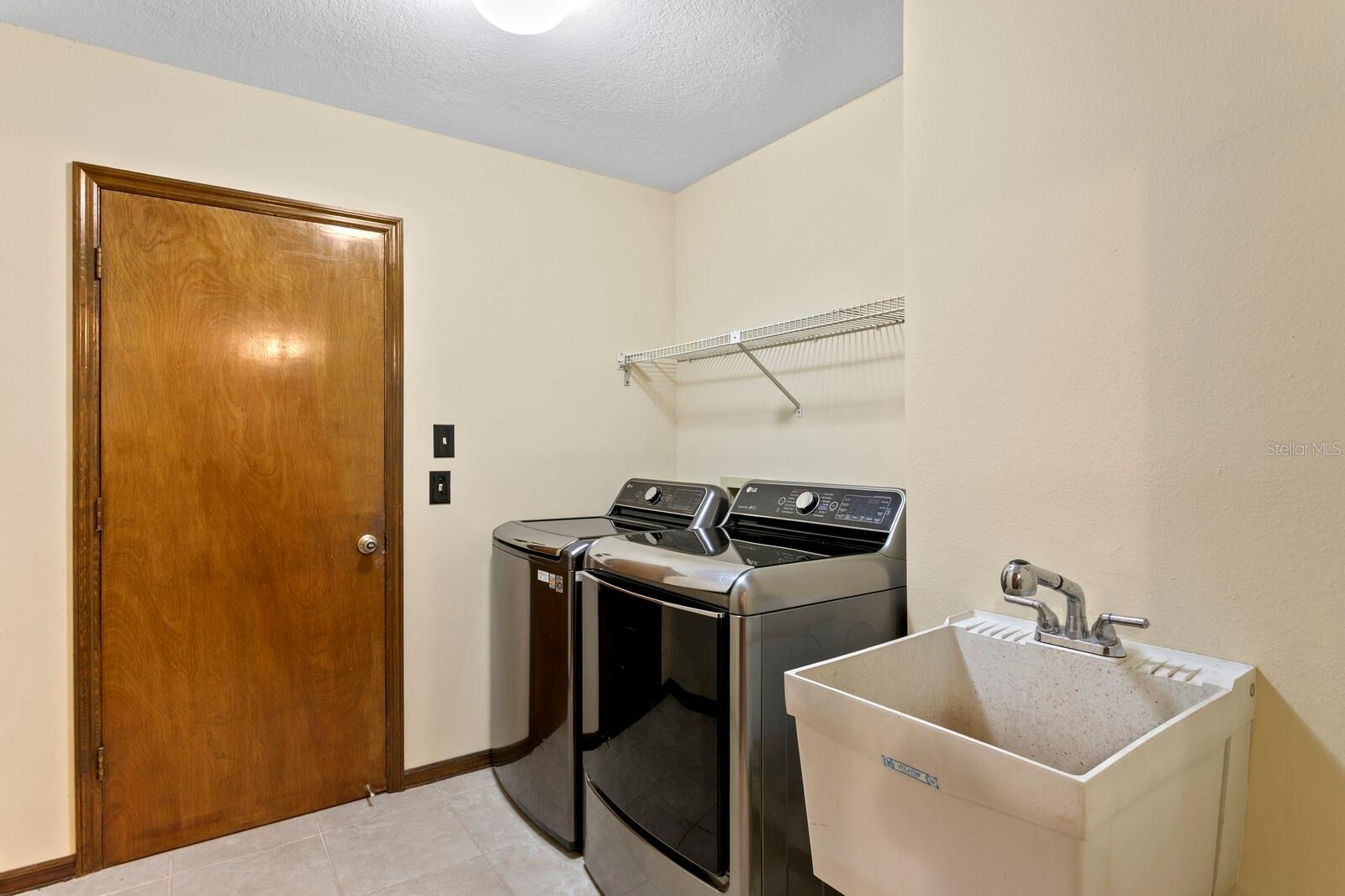 Inside utility room leads out to oversized 2-car garage