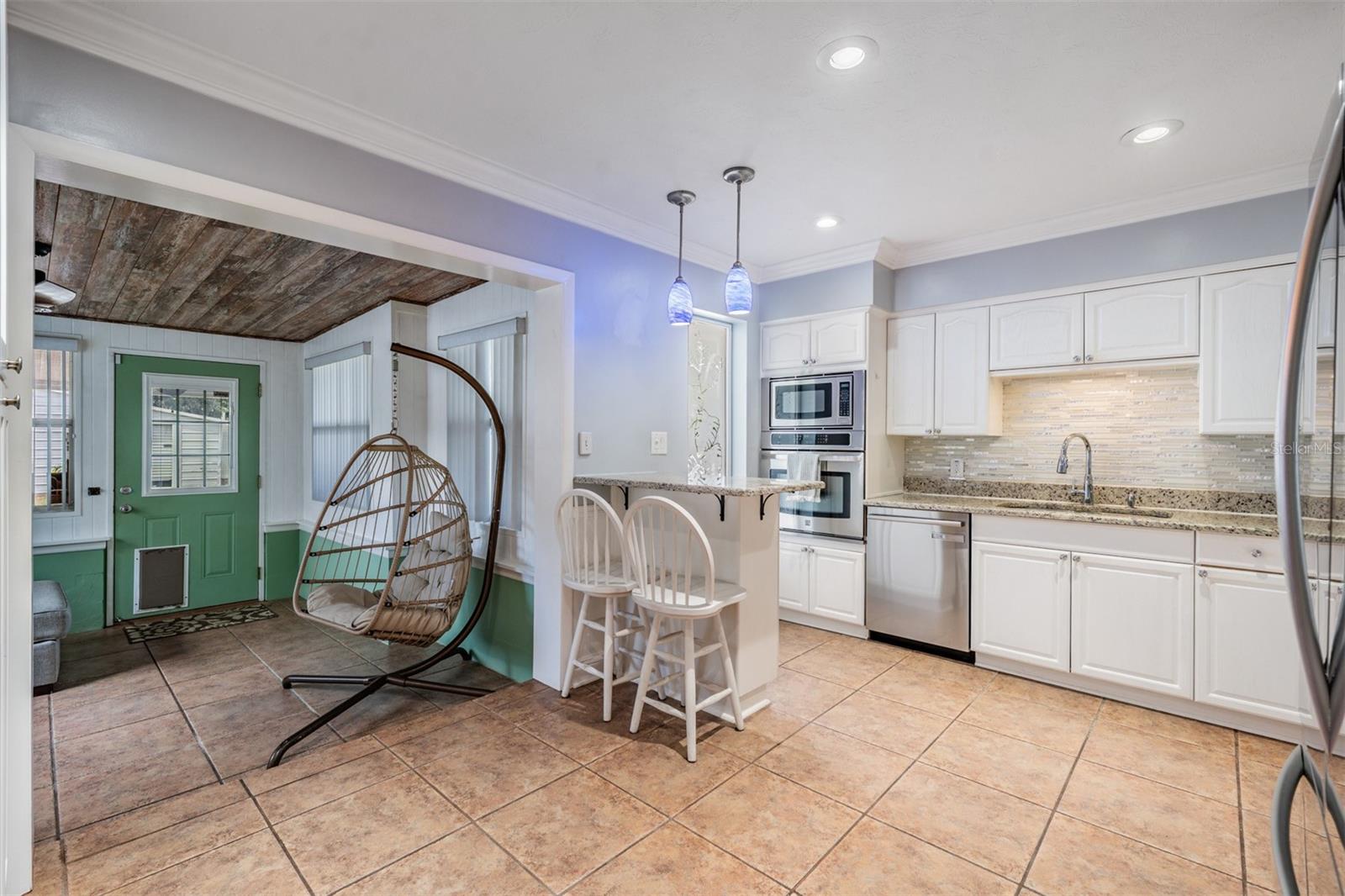 snack bar with storage, natural light floods the kitchen area