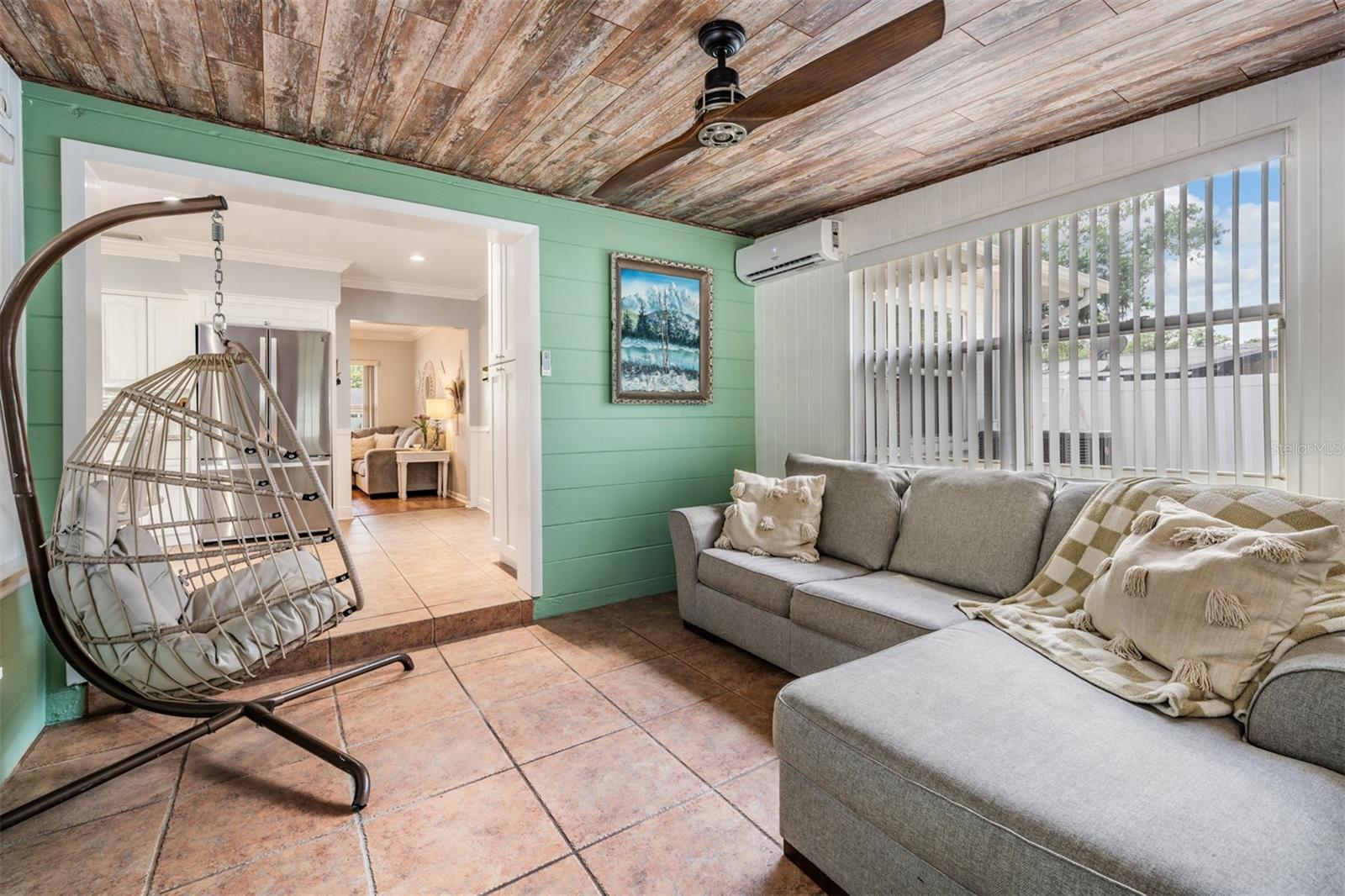 The Florida room that leads to the back yard offers additional space to use in many ways.  Shiplap ceiling and mini split cooling system keep this room quite comfy.