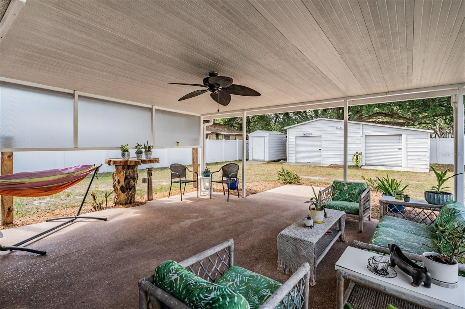 covered lanai, storage shed, workshop and large backyard