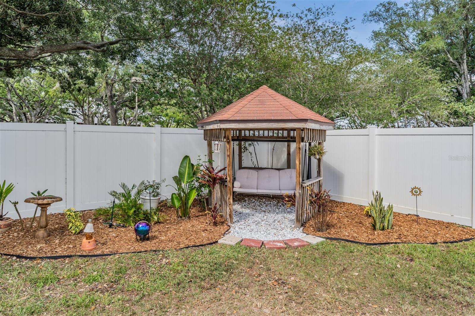 beautifully landscaped corner with seating area