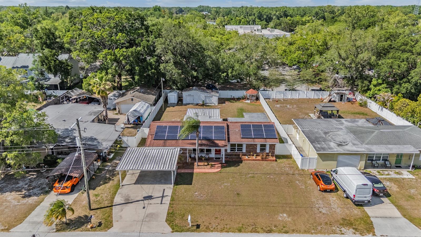 large fenced in yard wtih carport.  Solar panels convey via agreement with solar panel company-loooowww electric bills