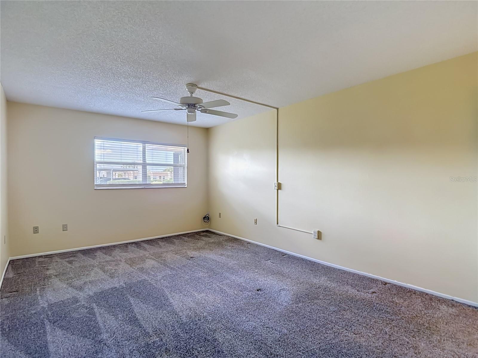 Primary bedroom with ceiling fan