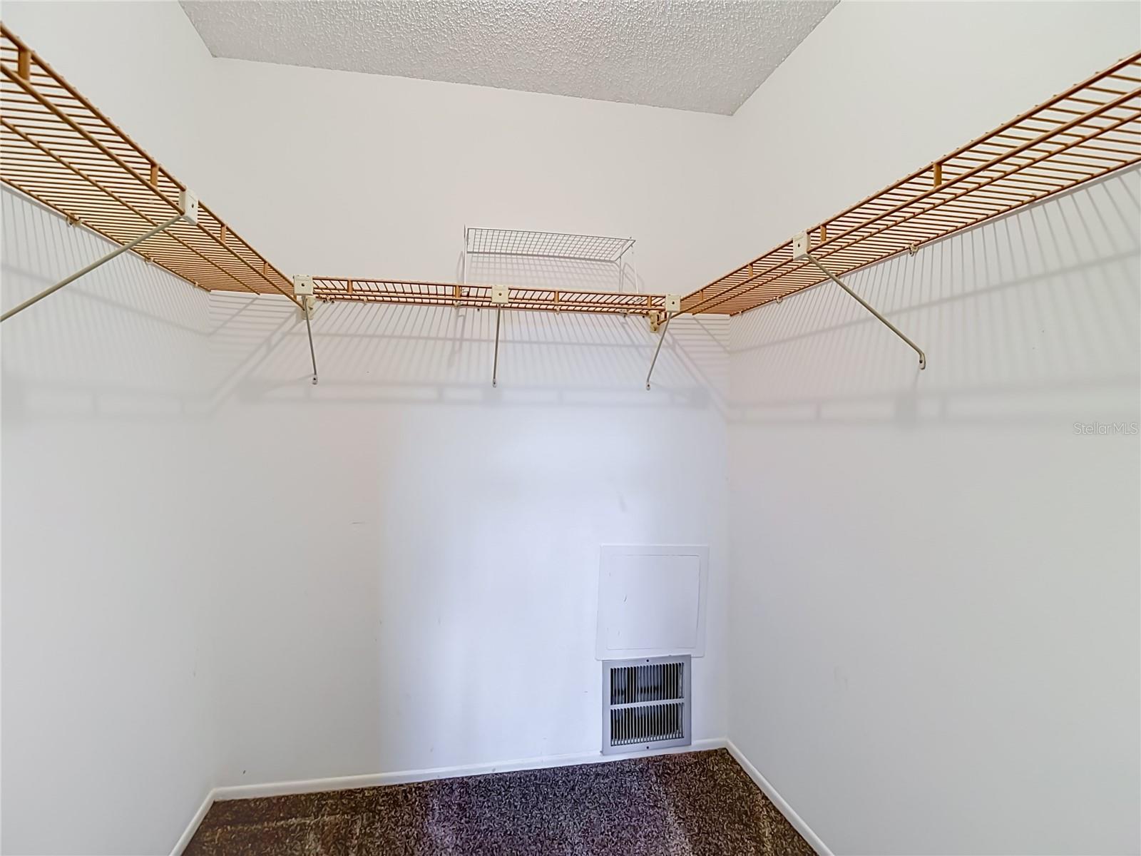 Primary bedroom walk in closet