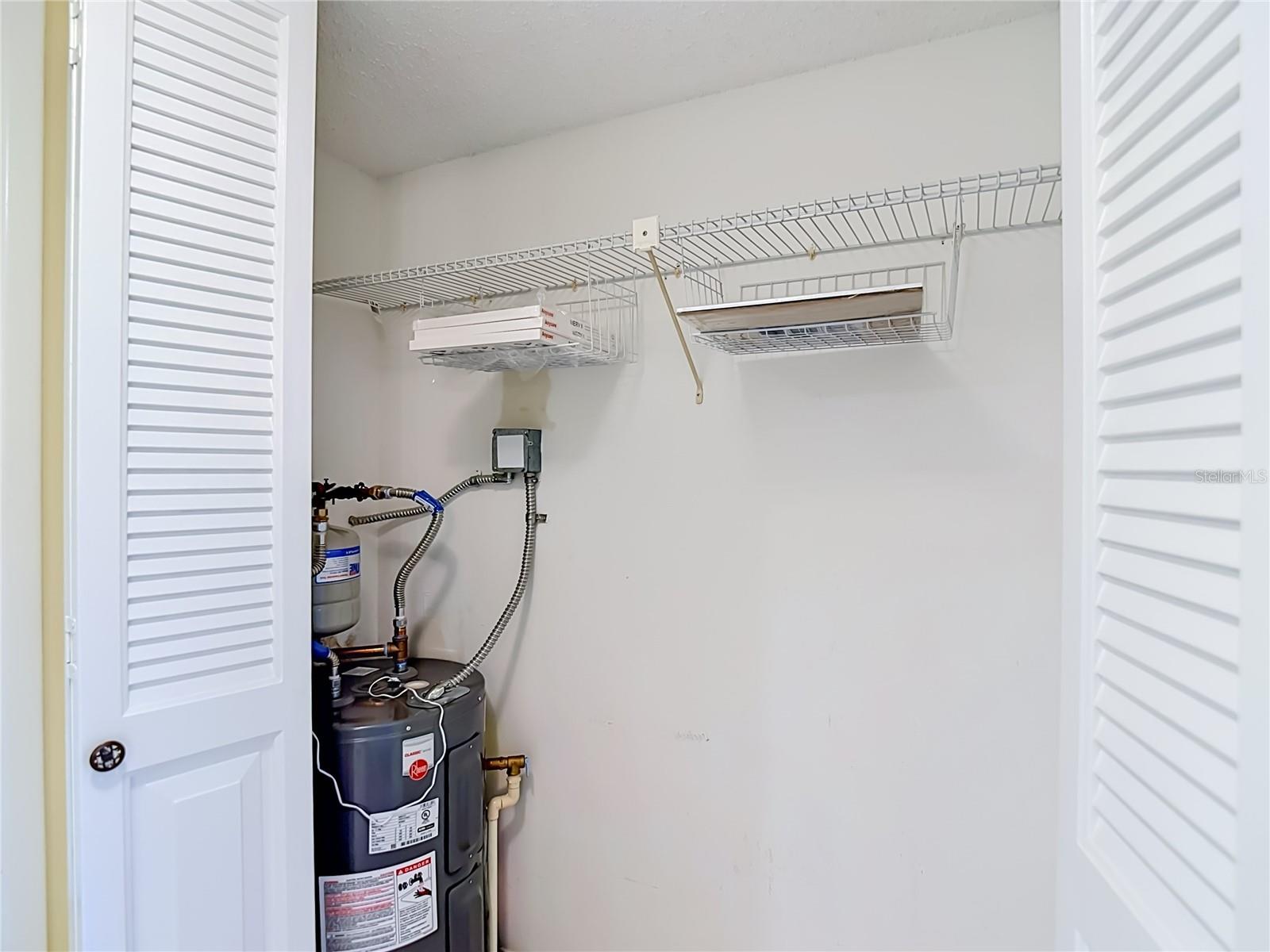 hall closet with electric water heater