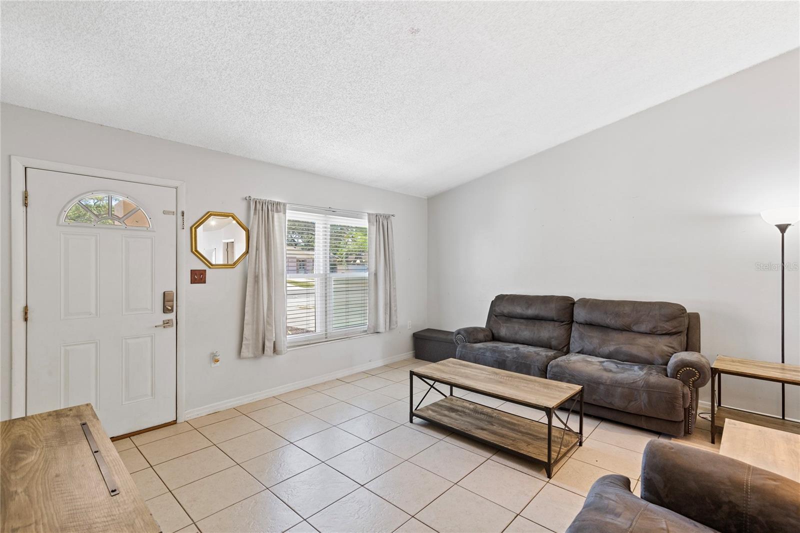 Living room with small coat closet by front door