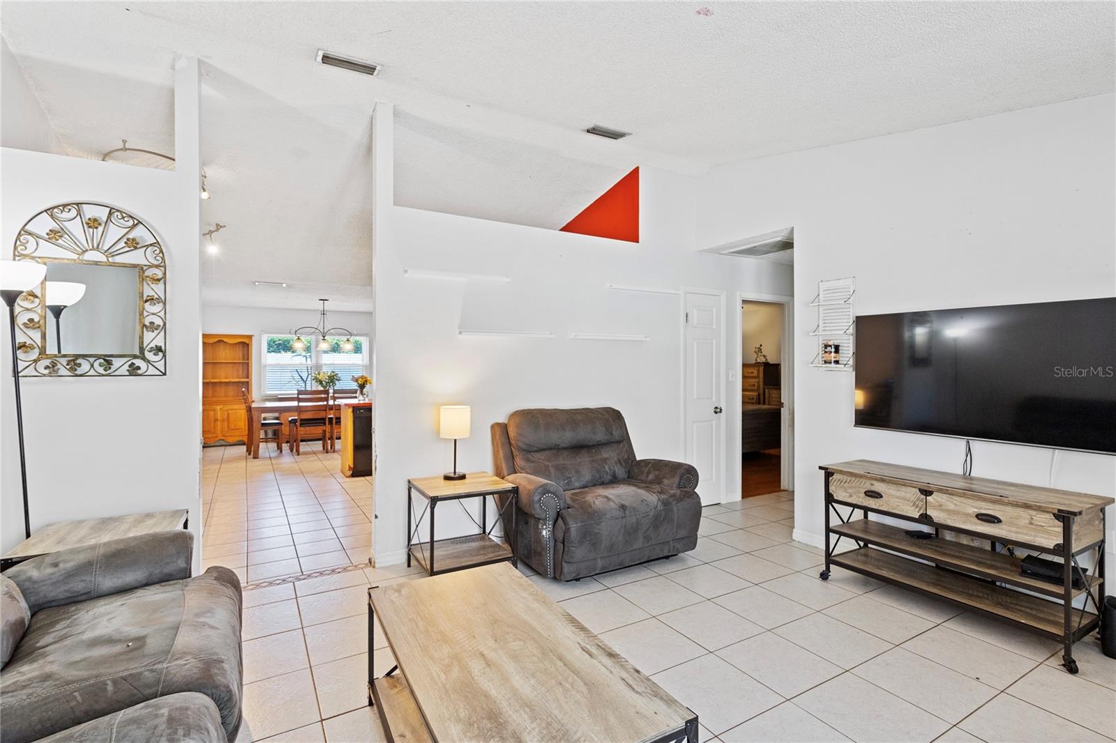Living room leads into kitchen dining combo with additional storage closet