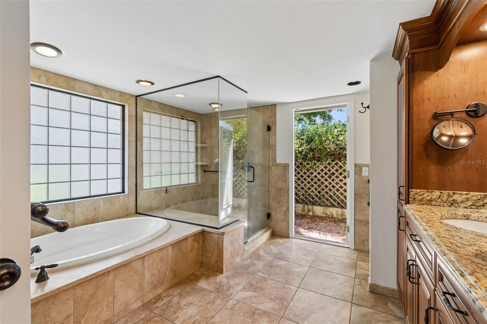 Primary bathroom with access to a private patio